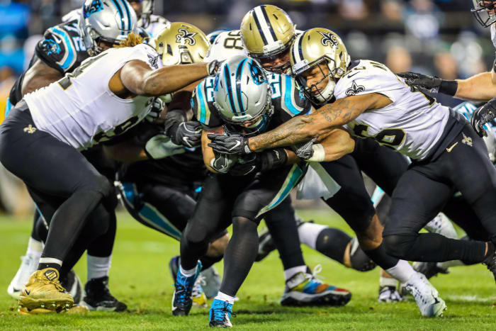 Carolina running back Christian McCaffrey (22) is wrapped up by the New Orleans Saints defense. Mandatory Credit: Jim Dedmon-USA TODAY Sports